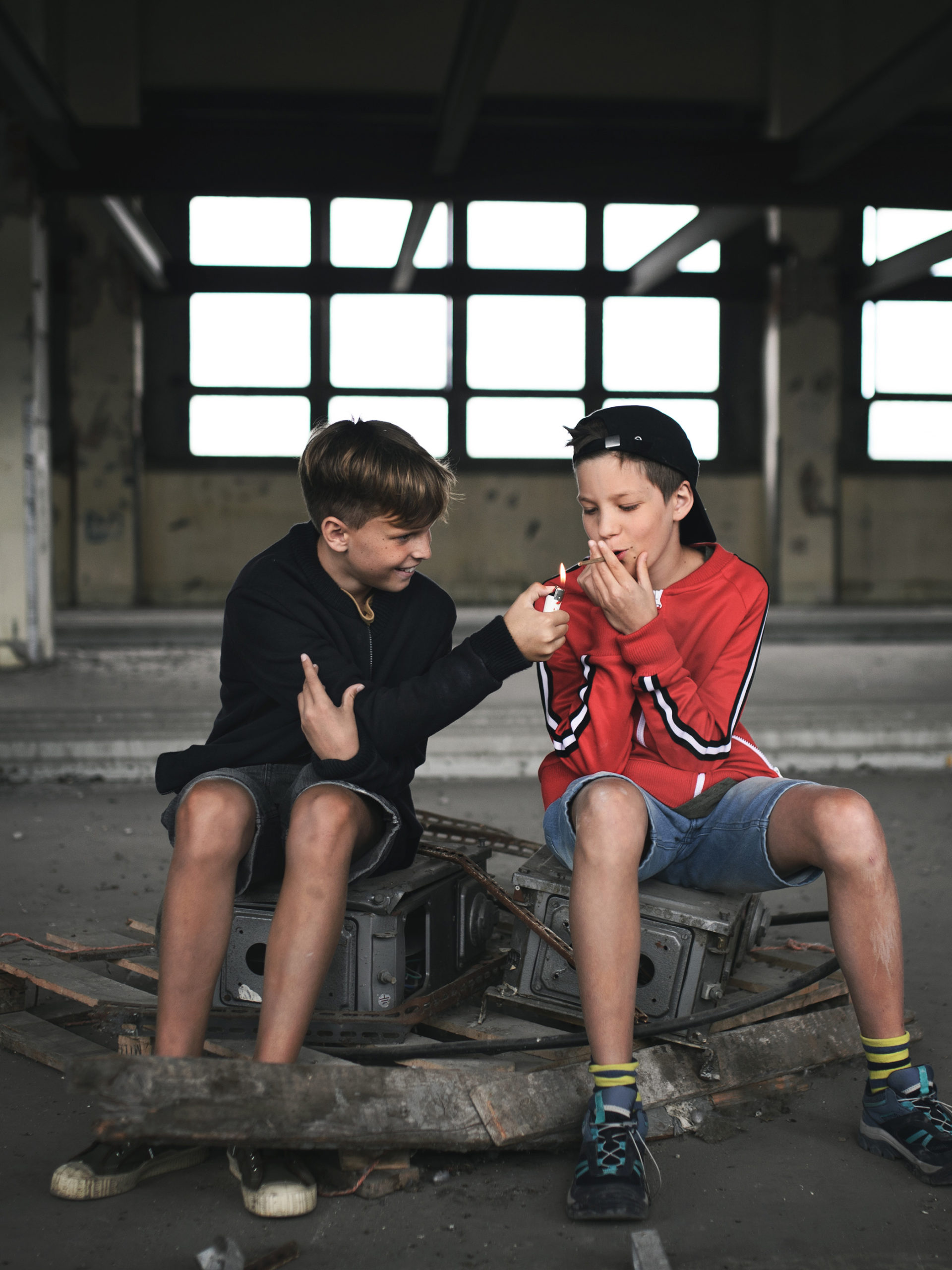 Group of teen boys in abandoned building smoking