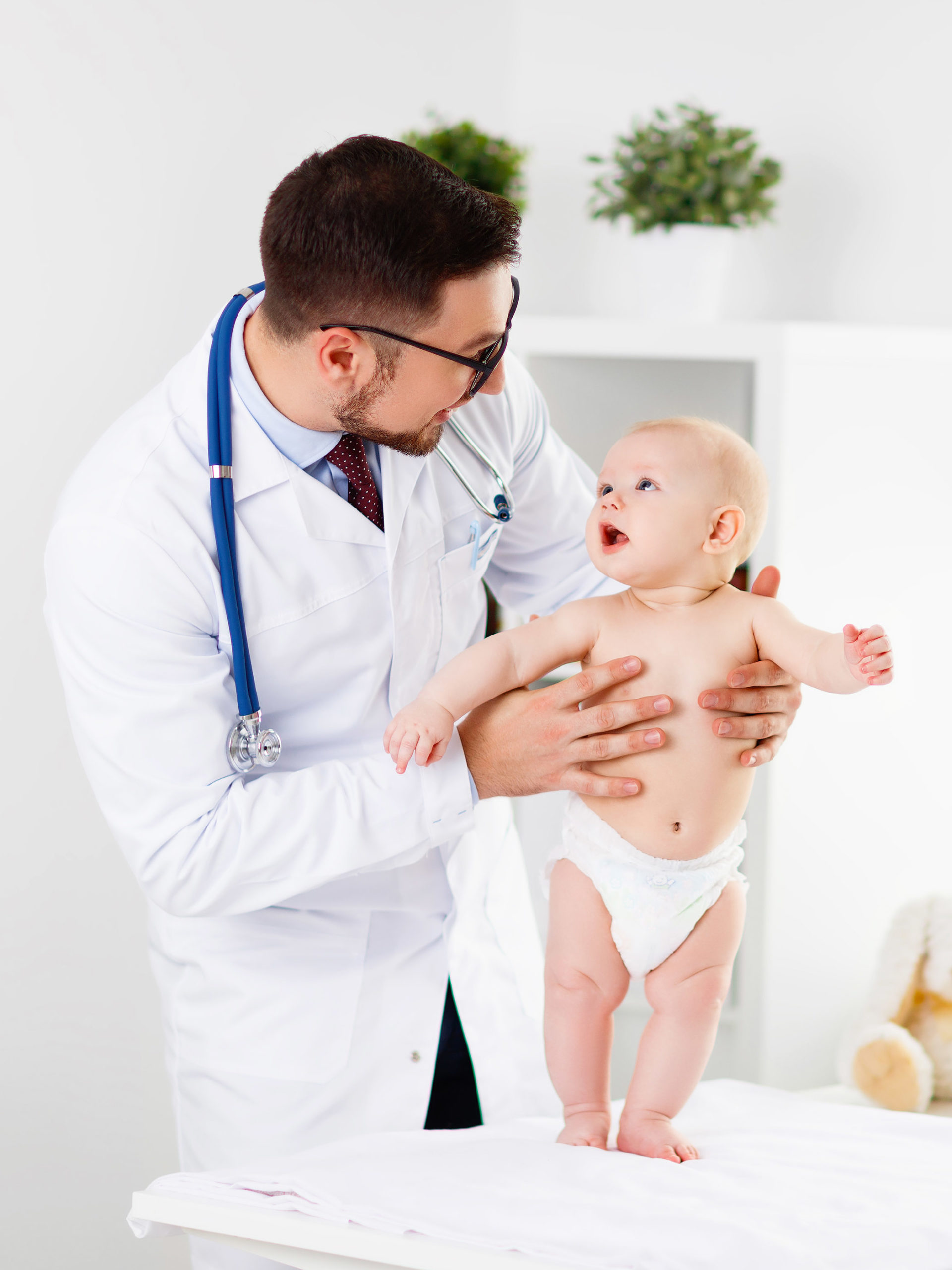 Doctor pediatrician with baby child in clinic