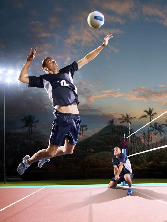 male volleyball players in action on the night court
