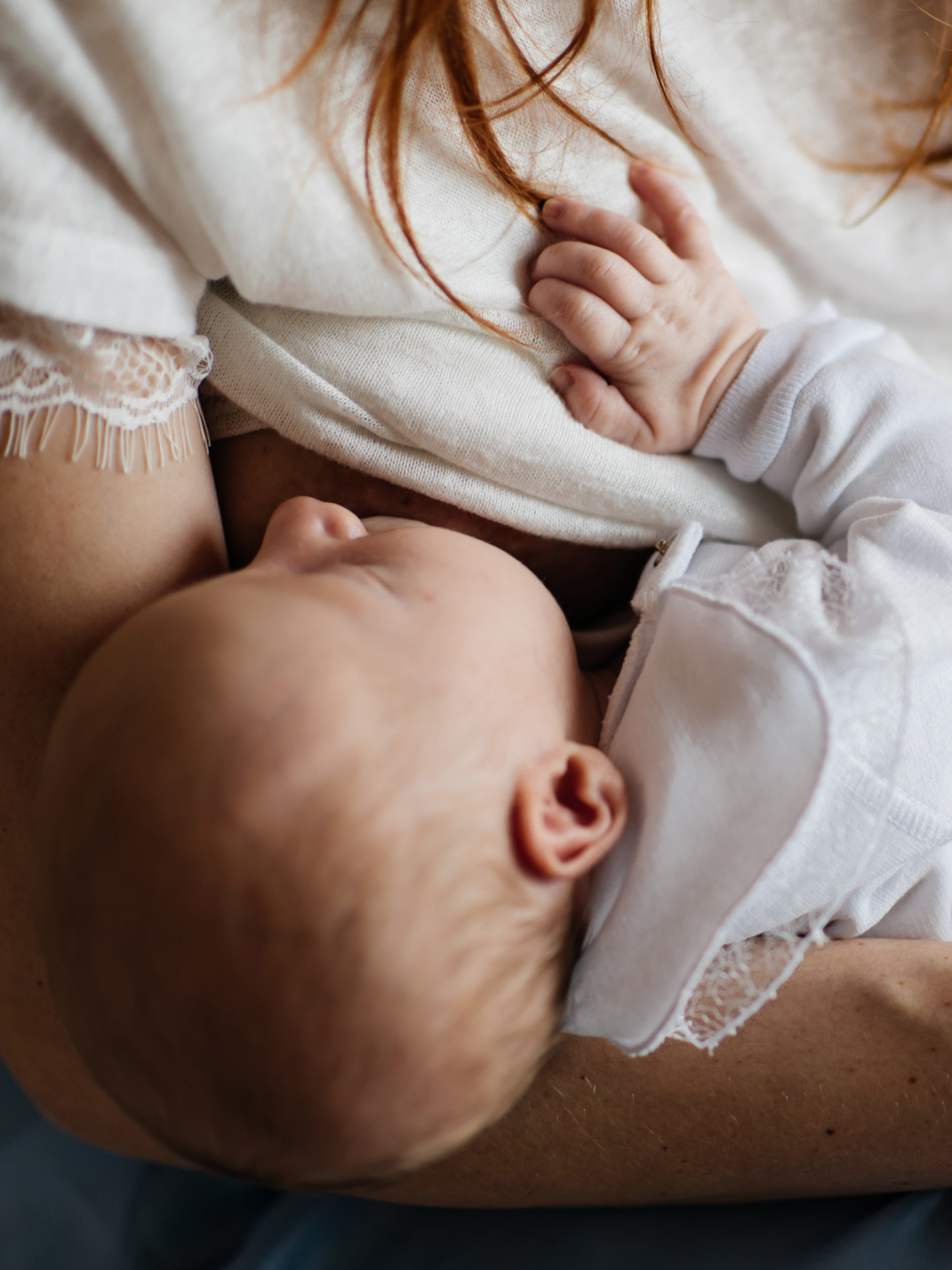 Newborn baby being breastfed by mother