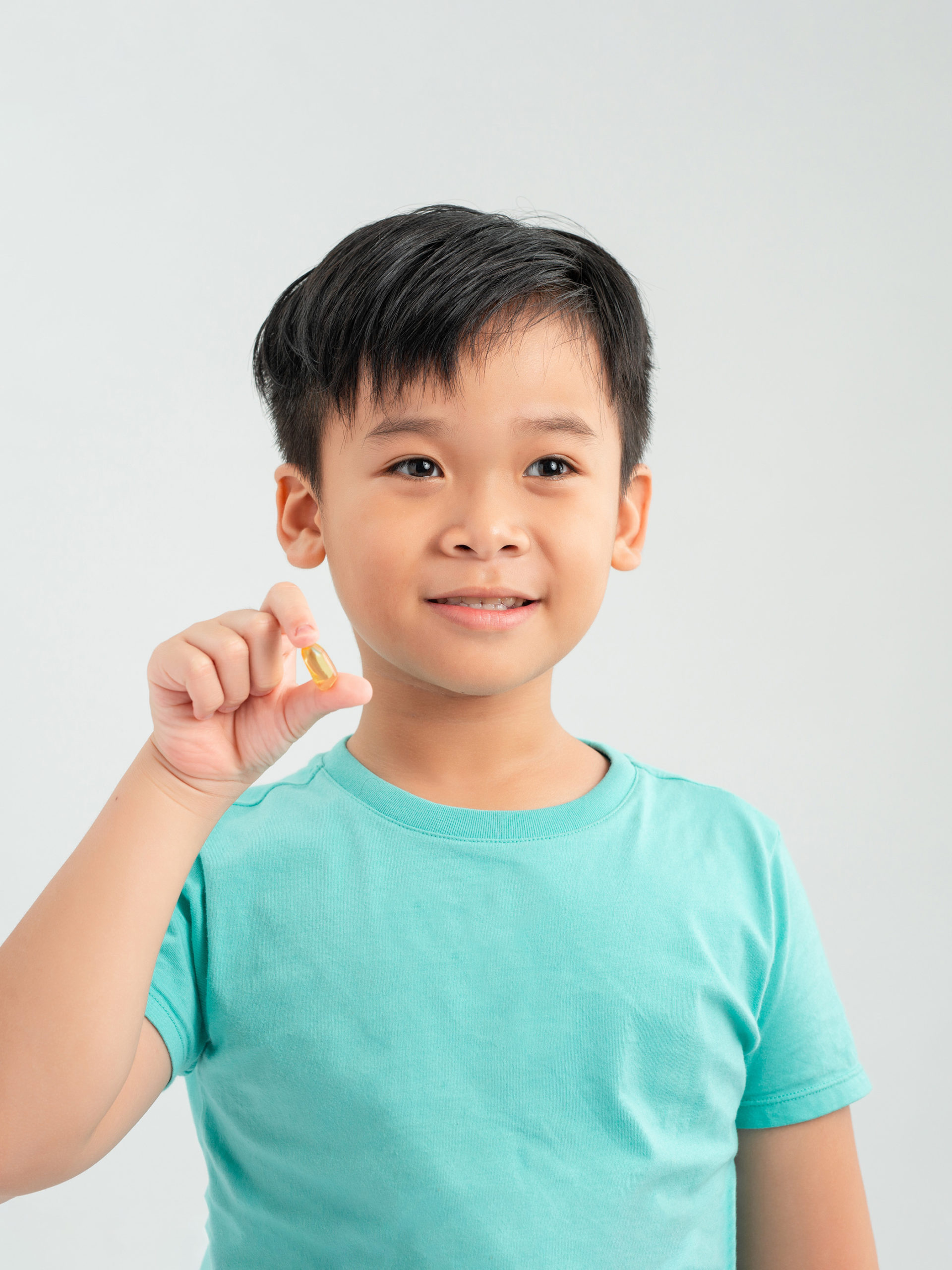Boy holds up pill and smilies