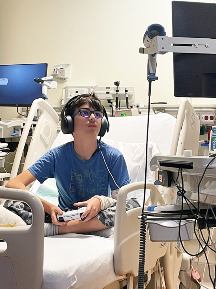Henry playing video games in his hospital room