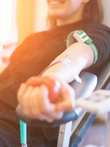 Arm holding stress ball donates blood