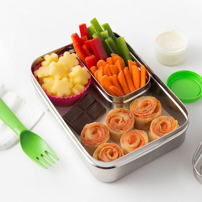 Pizza rolls in a metal bento box with carrot and celery sticks and chocolate 