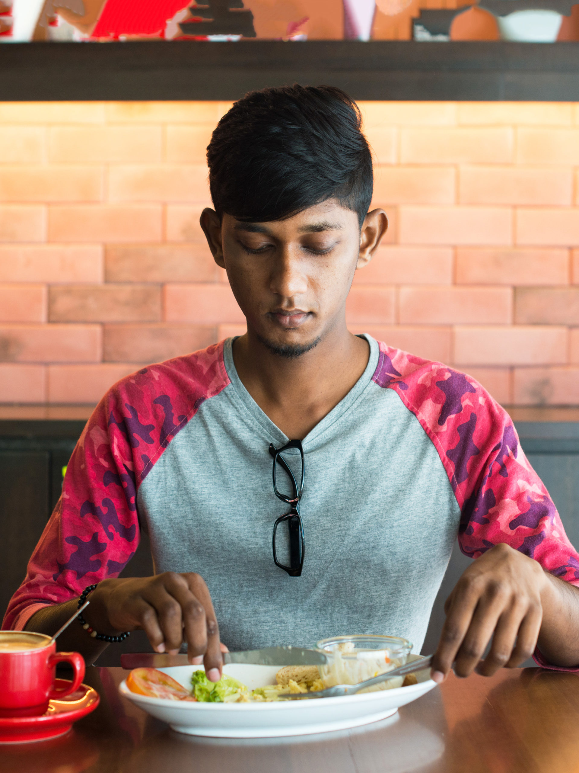 Teen sitting at table eating