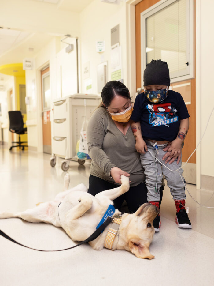 Mom and child visit with Lois, CHOC's resident therapy dog