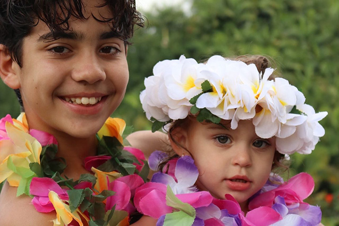 boy and girl wearing hawaiian leis 
