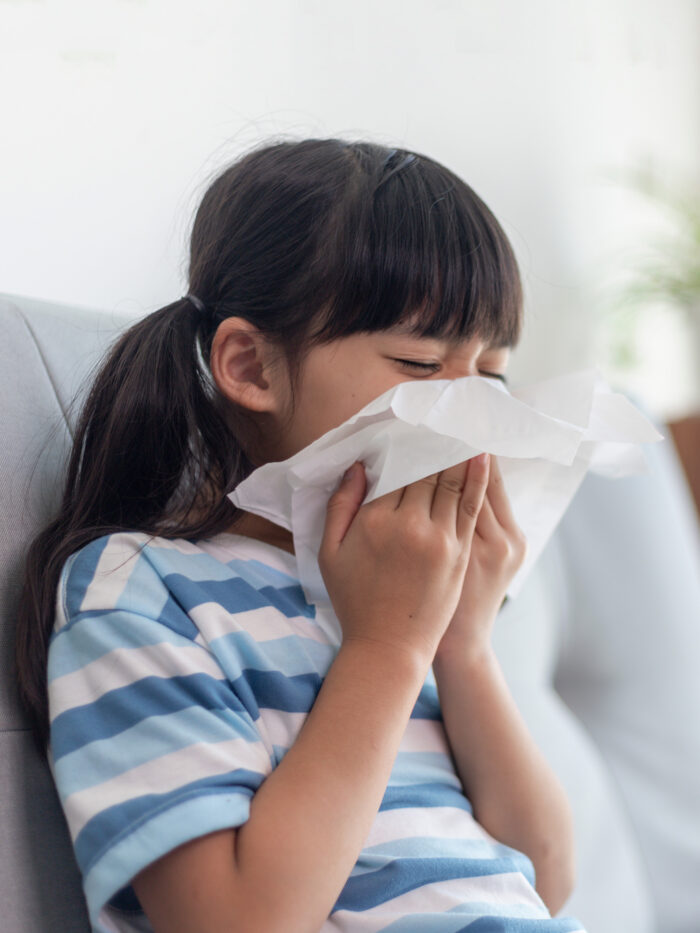 Little girl blows nose because of RV, EV, EV-D68 viruses