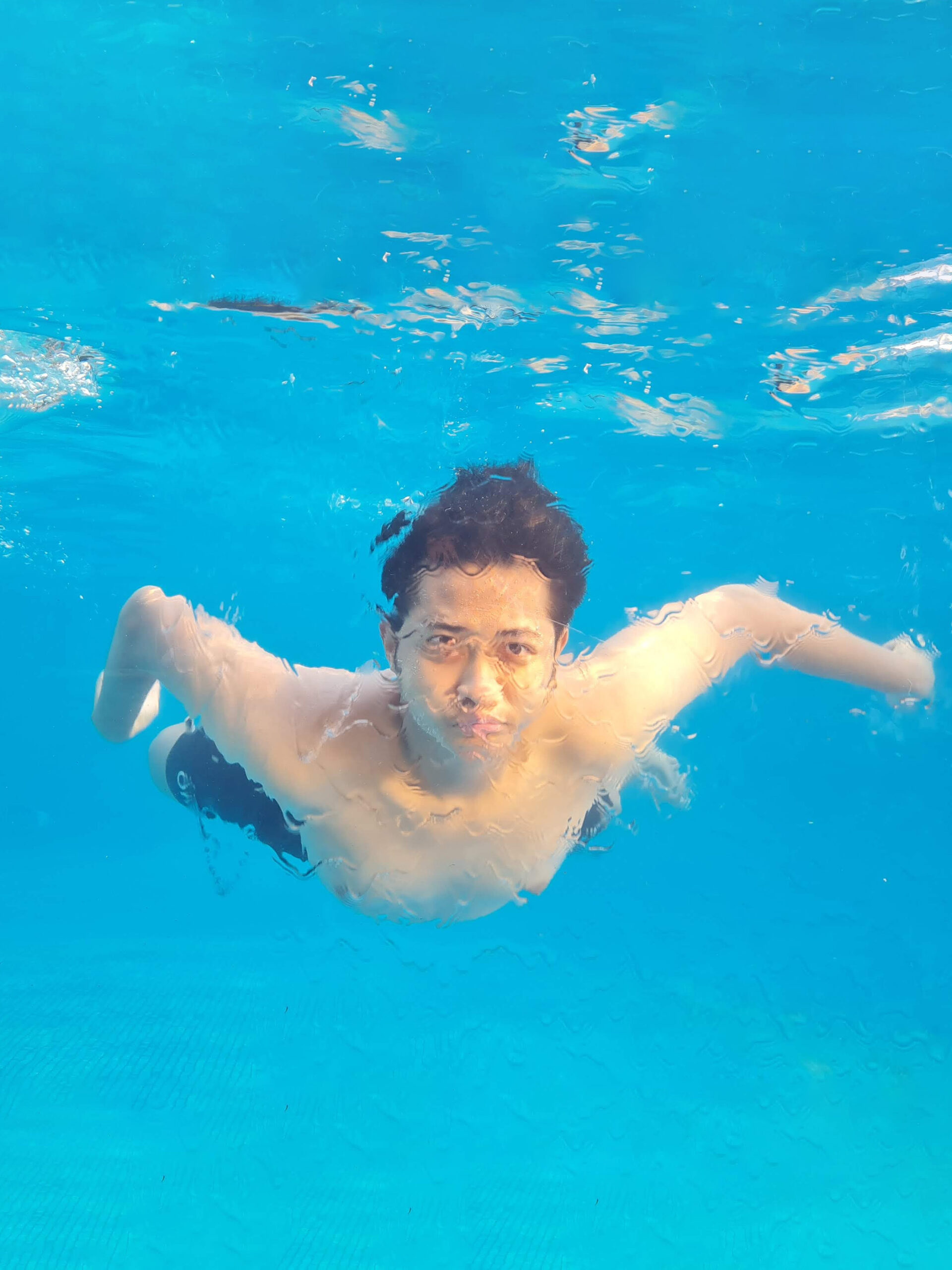 Teen swimming underwater