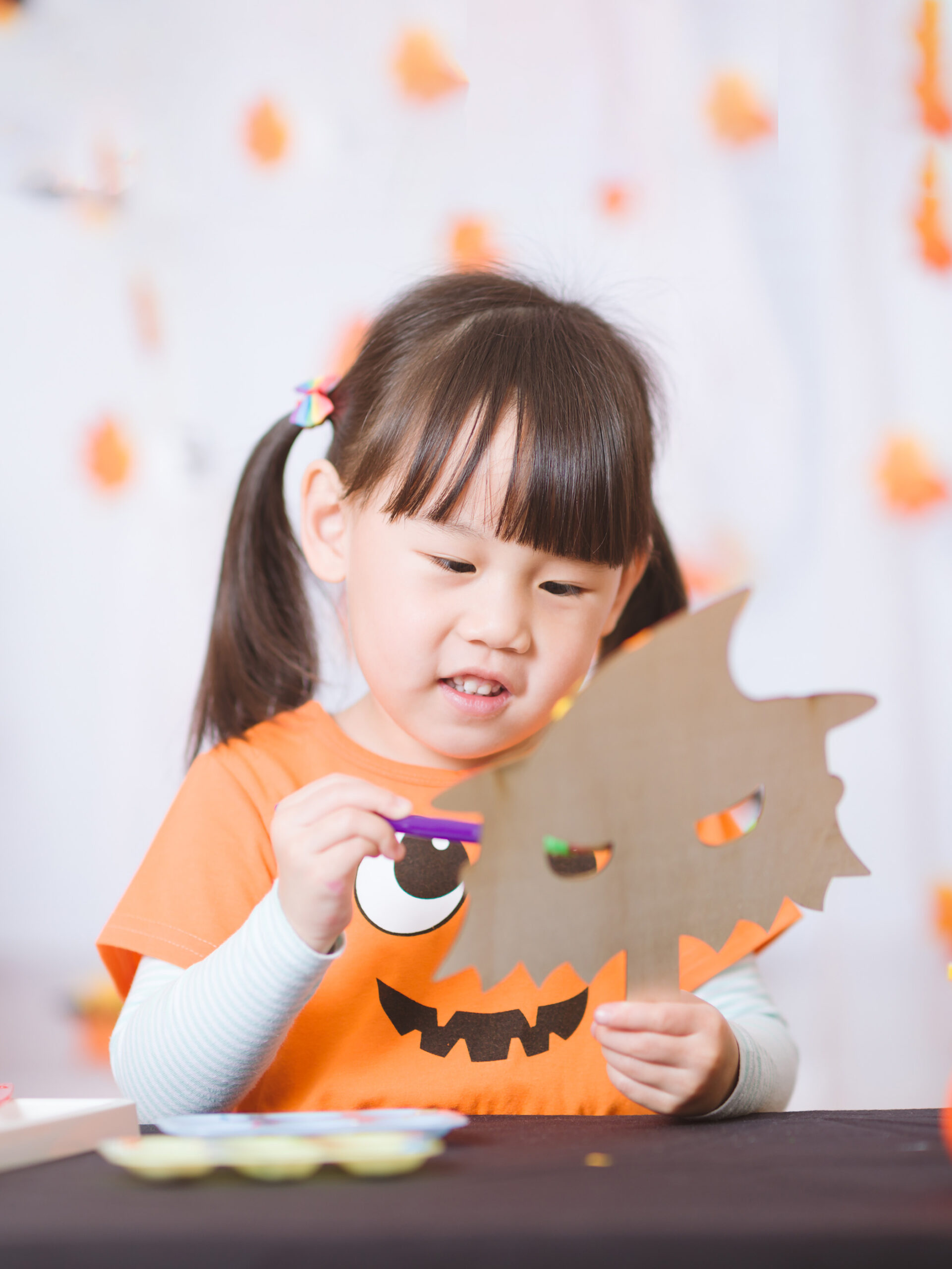 Little girl who is nervous about Halloween does a Halloween craft