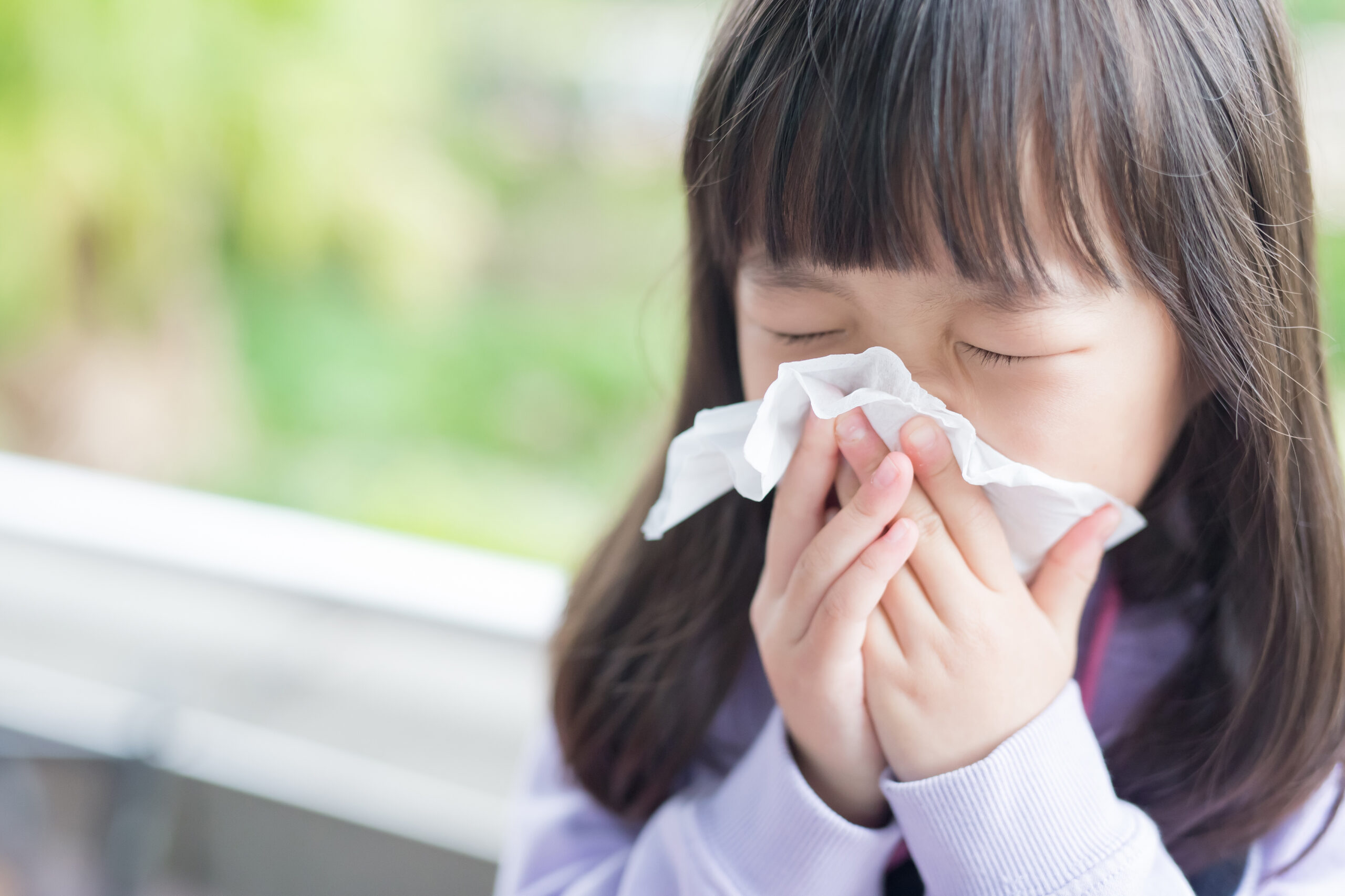 Child blows nose from respiratory illness