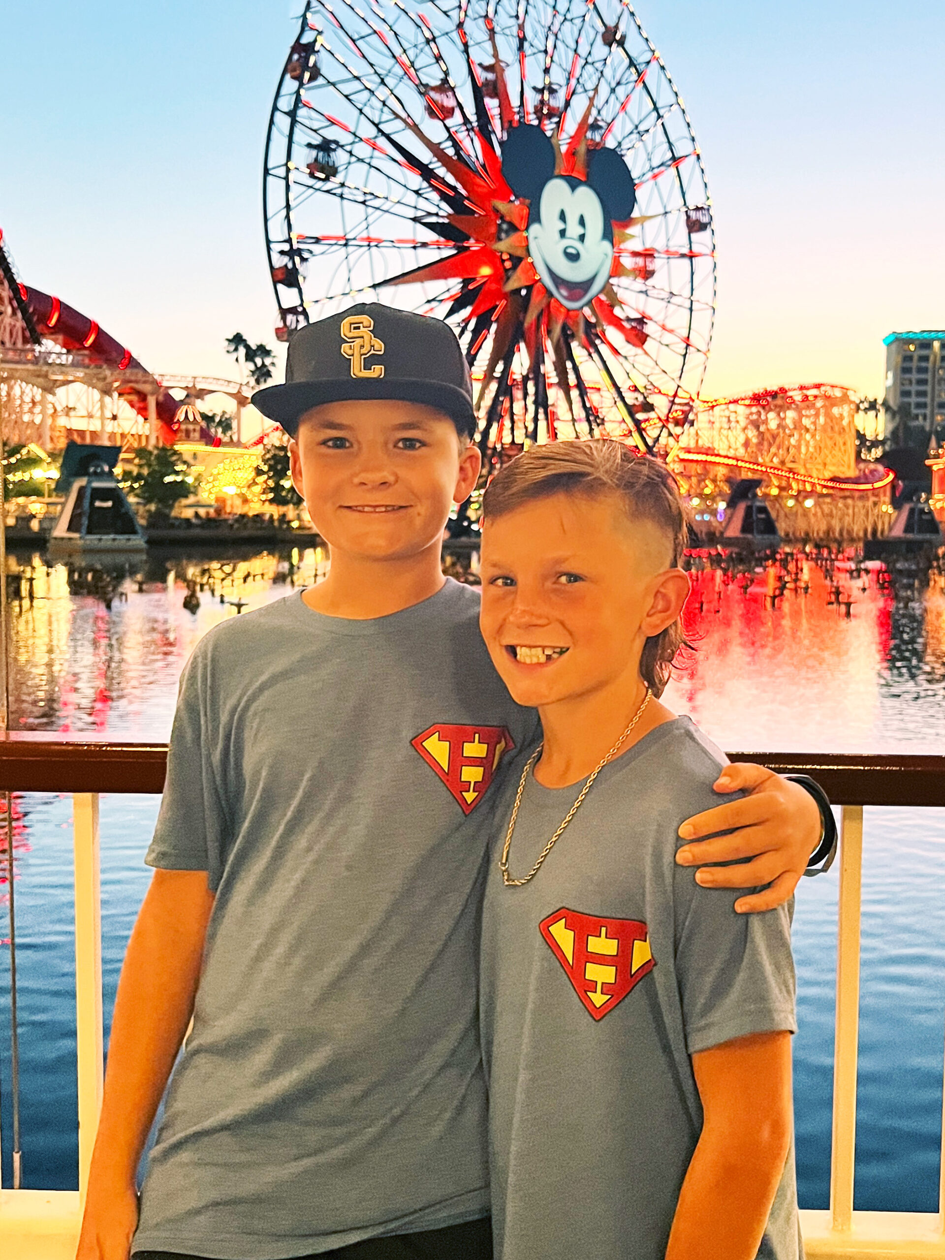 Hudson and Cole smiling together at Disney California Adventure.