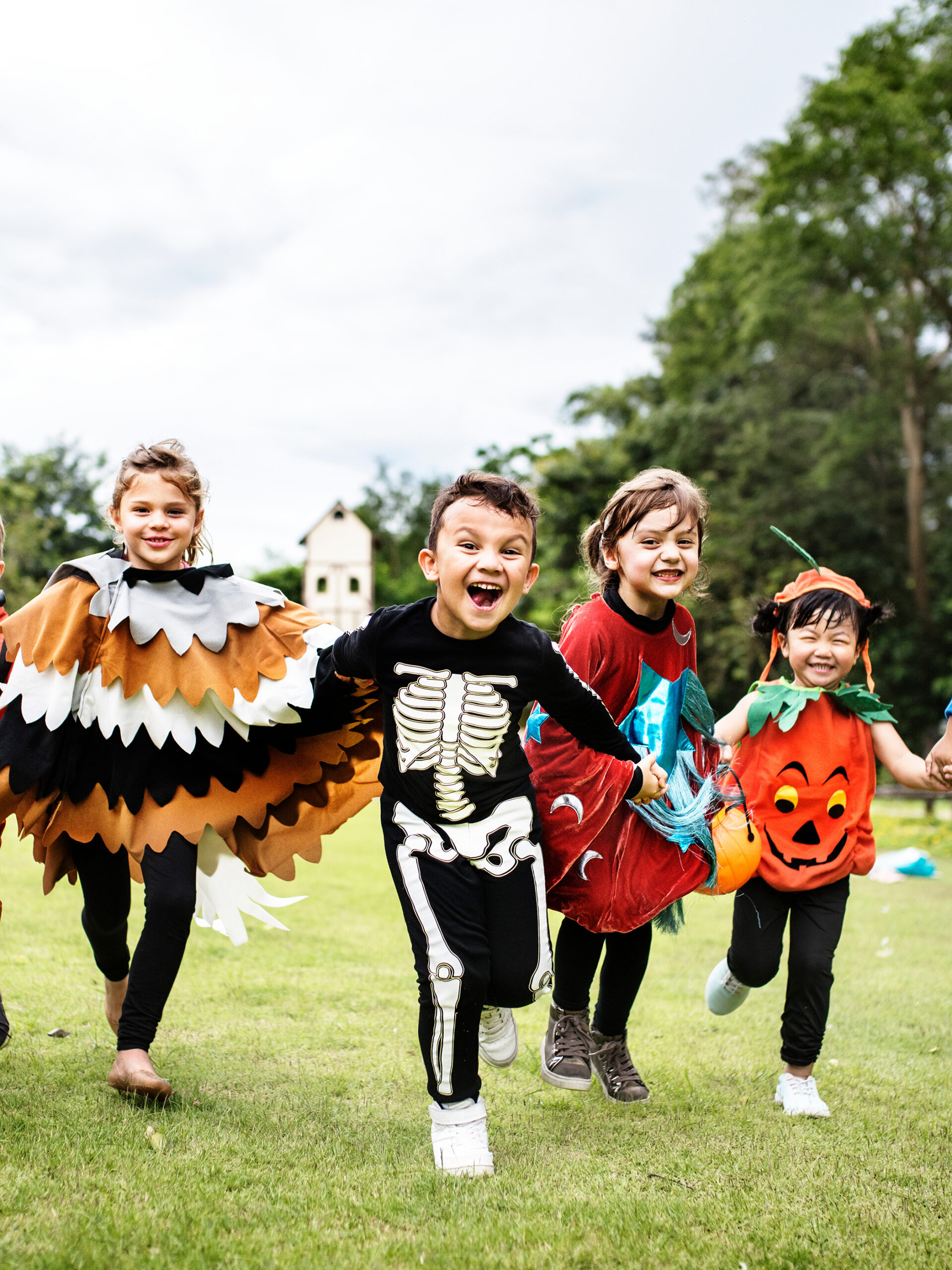Kids wearing Halloween costumes run toward the camera
