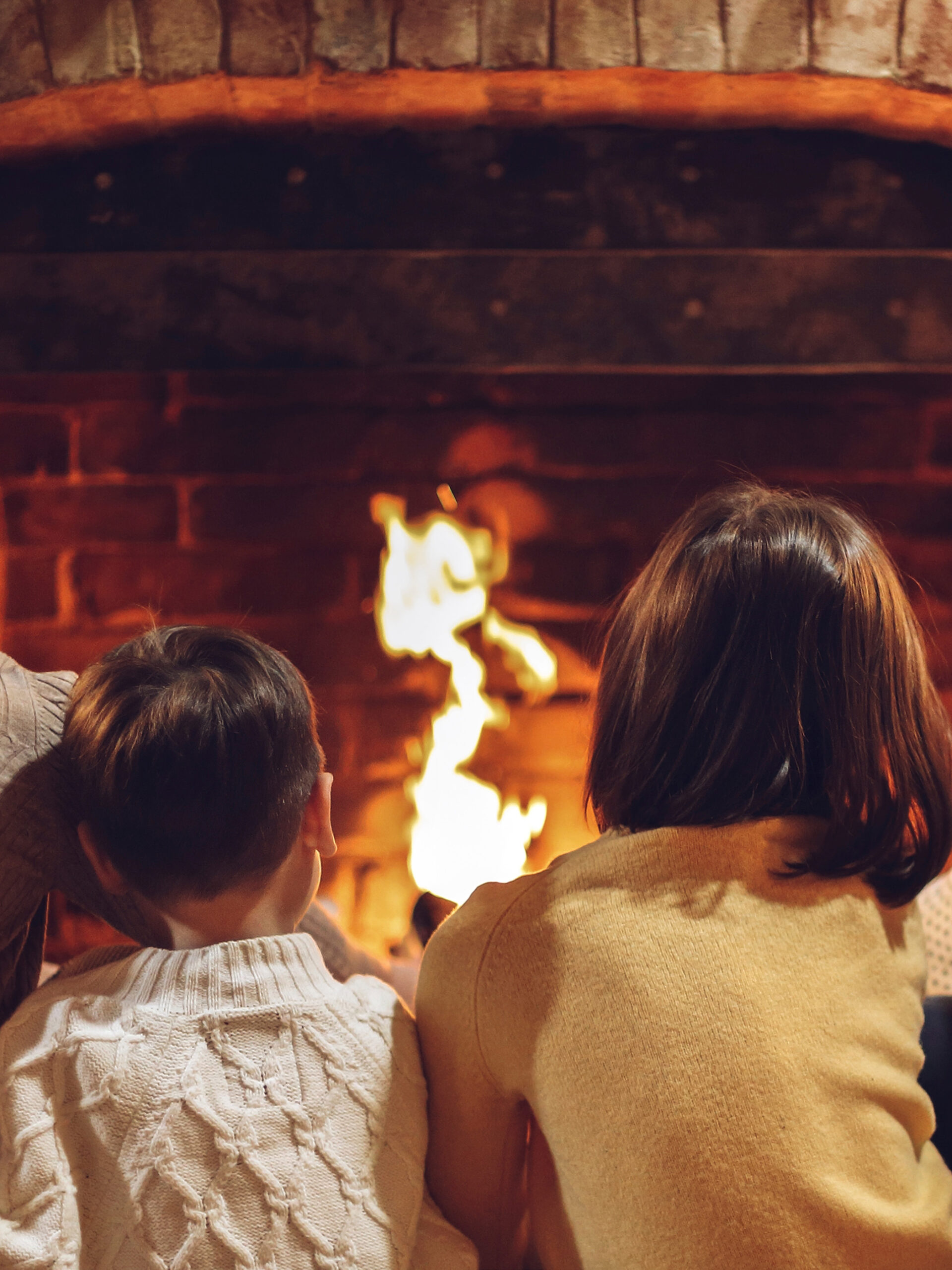 Two kids sit in front of fire - holiday safety tips for families from CHOC