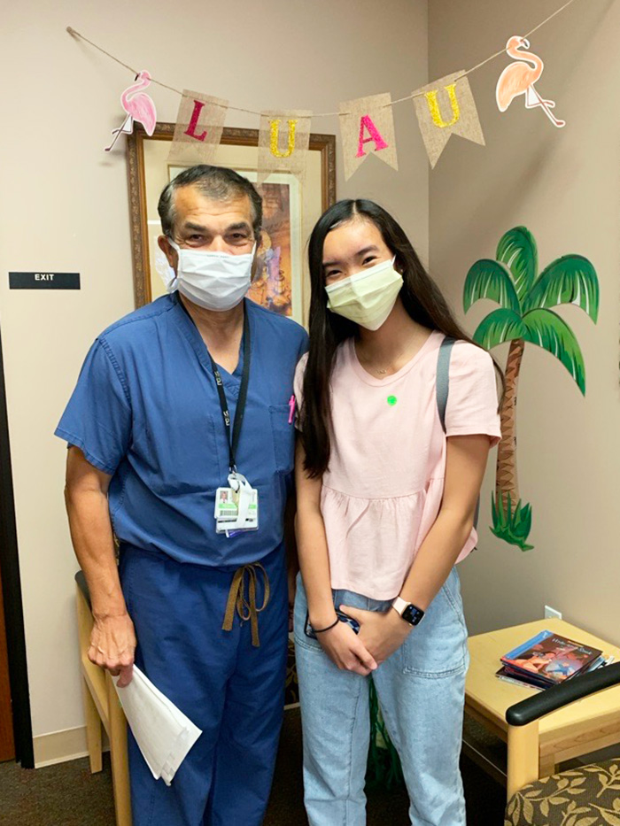 Avery smiles with Dr. Troy Reyna 