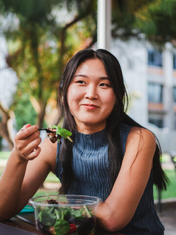 Teenager eats salad - healthy eating habits to help prevent childhood obesity