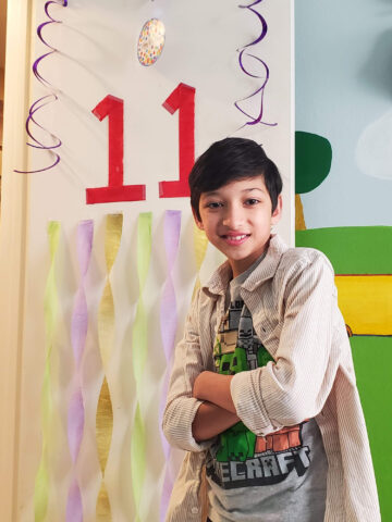 CHOC patient Isa poses with 11th birthday decorations