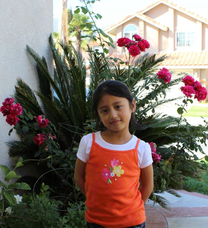 Lynn Wu, age 7, smiles into camera 