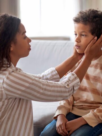 A mother examines her child's face