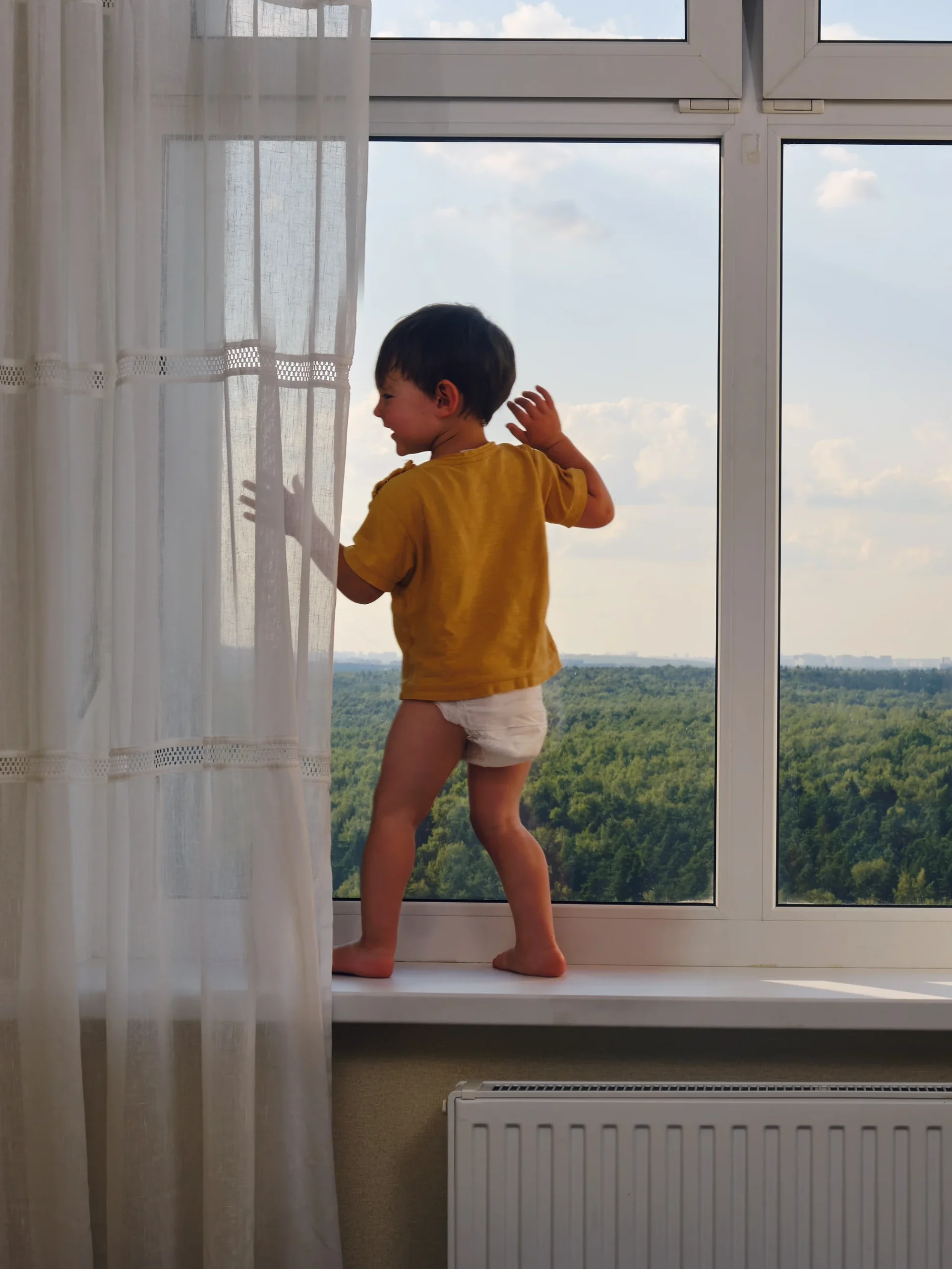 Child on window ledge