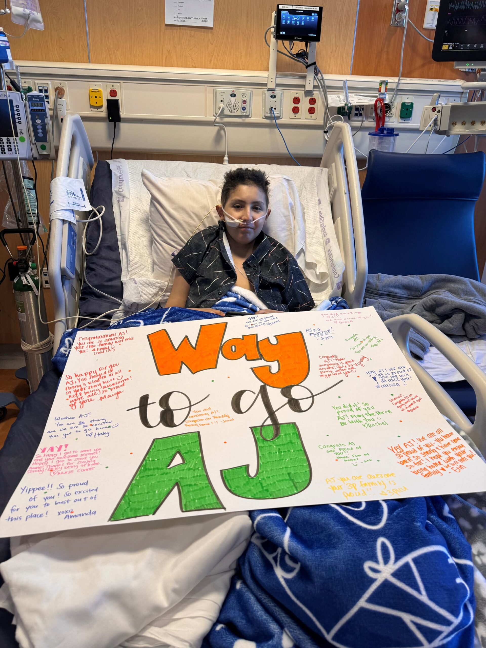 Boy in hospital bed with poster