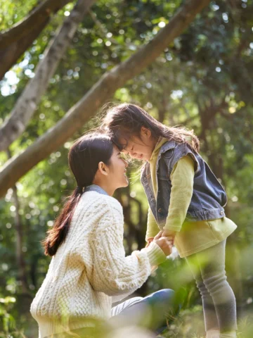 Parent and child hugging in nature