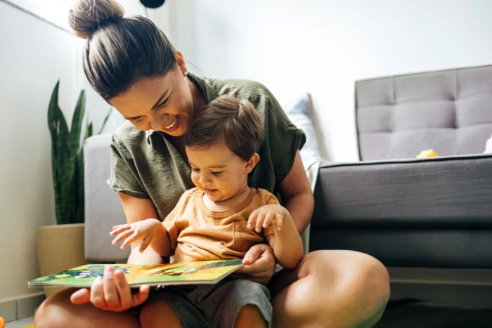 Son reads book with mom 