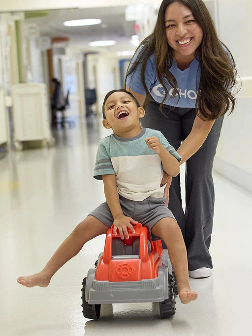 patient smiles with CHOC employee