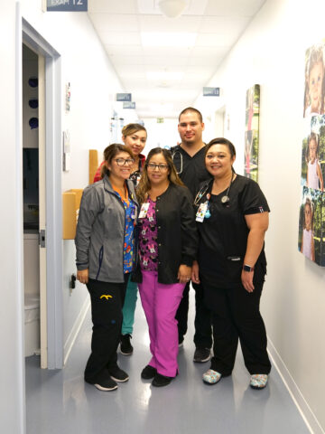 CHOC staff pose together and smile in hallway 