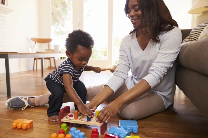 two-year-old and mom play together 