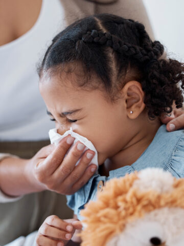 Child blowing her nose