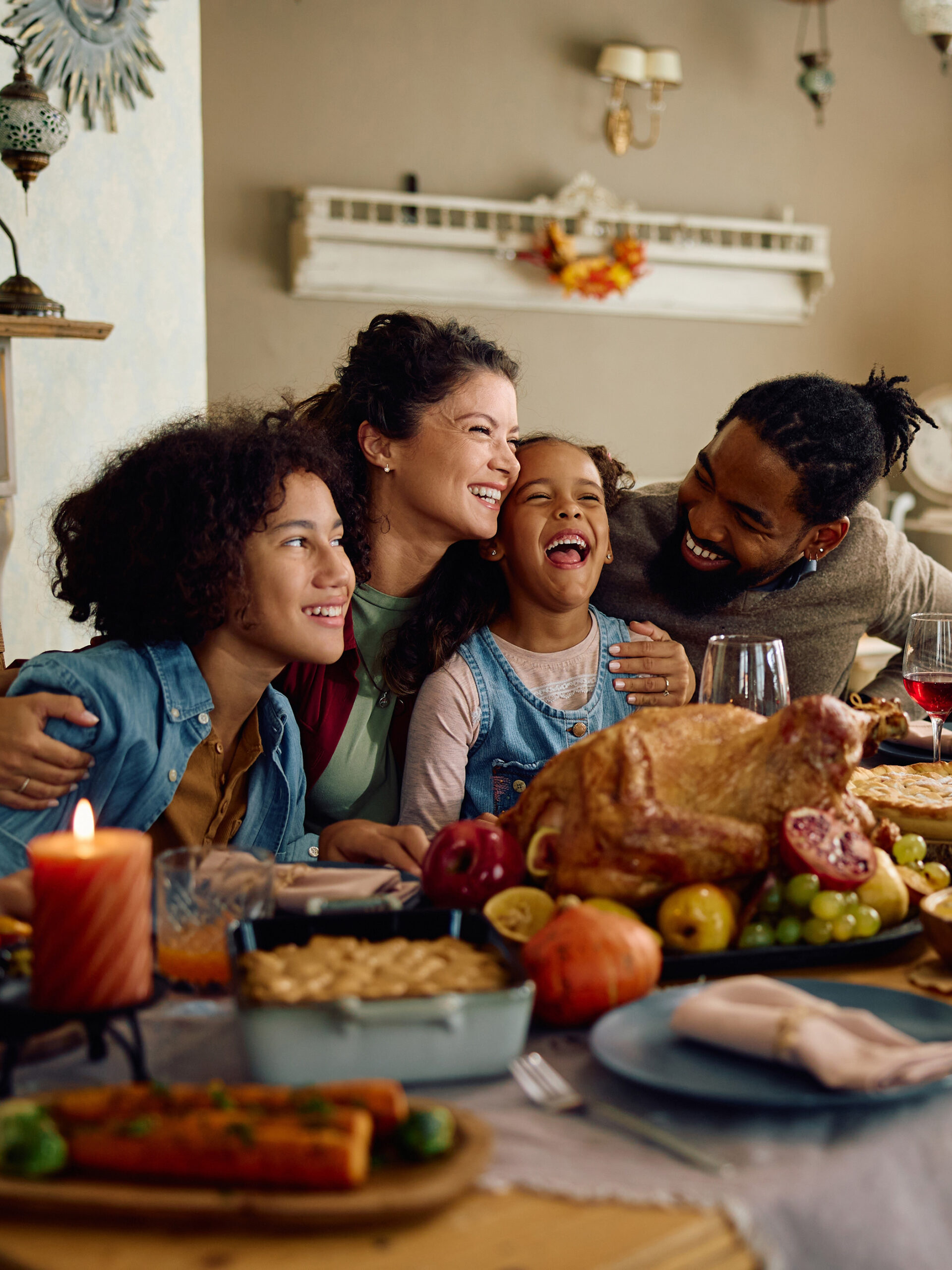 Family at holiday table smile together - CHOC dietitians offer holiday eating tips