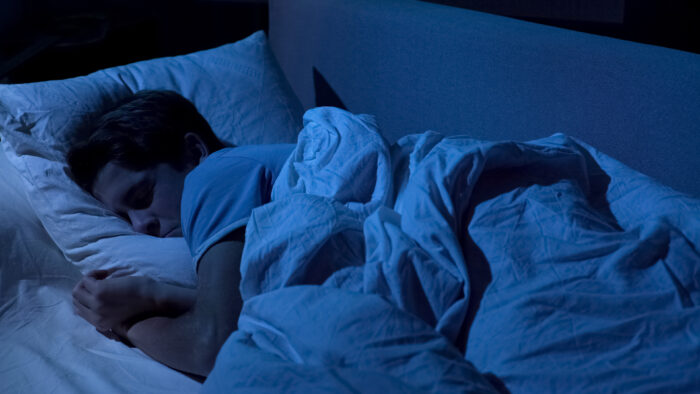 Teen sleeping in dark room