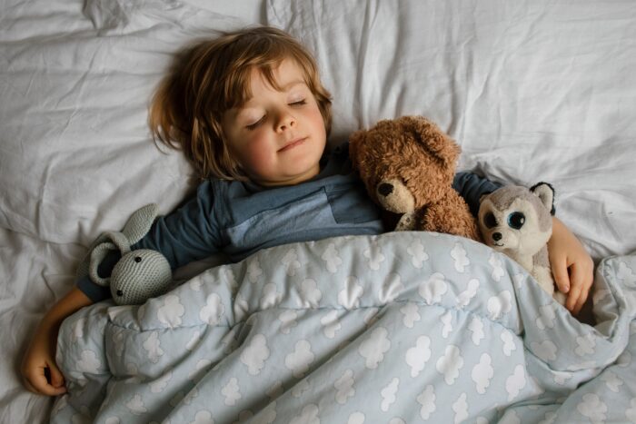 Toddler sleeping with stuffed animals