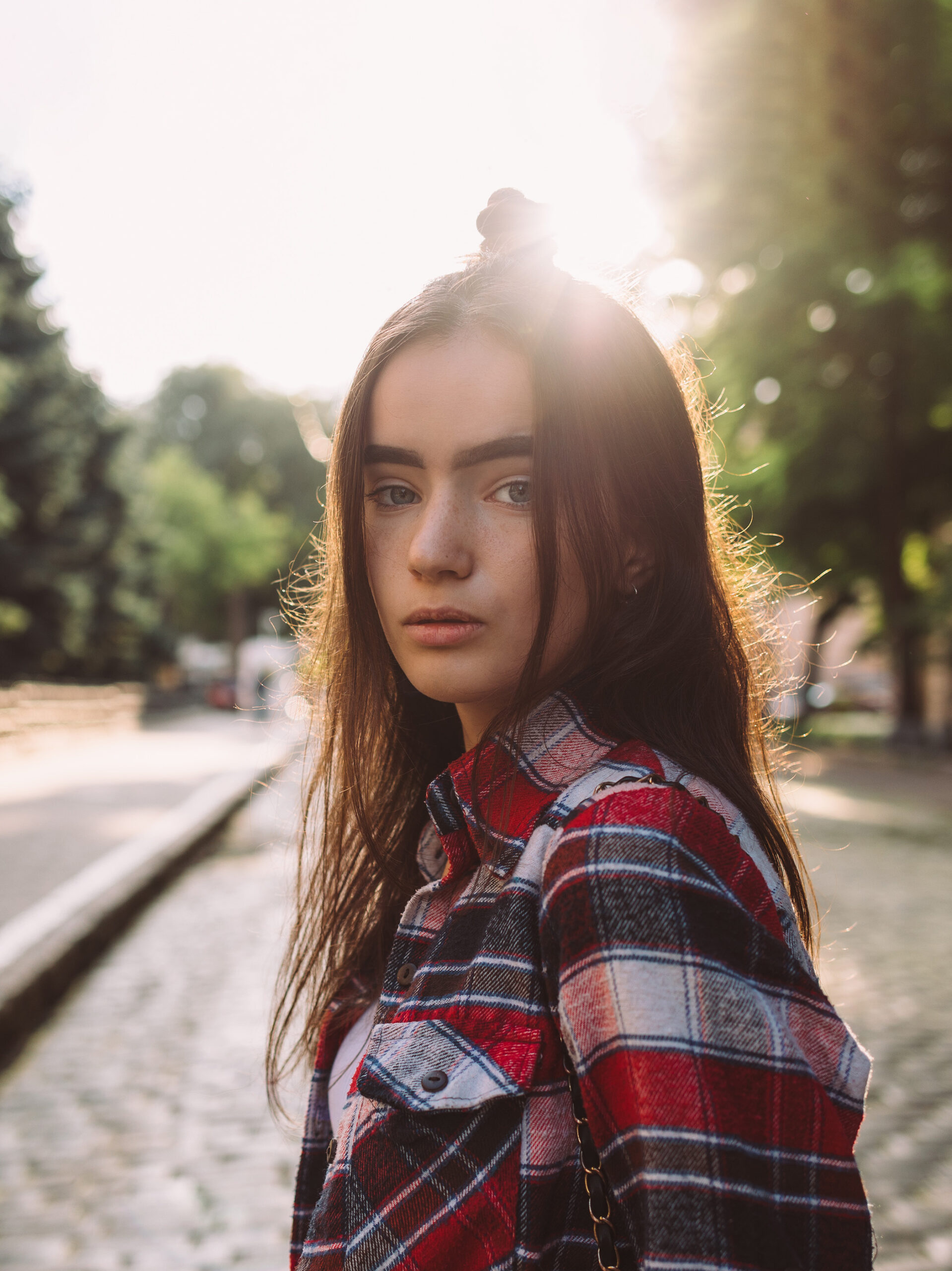 Girl looks over at camera with neutral expression