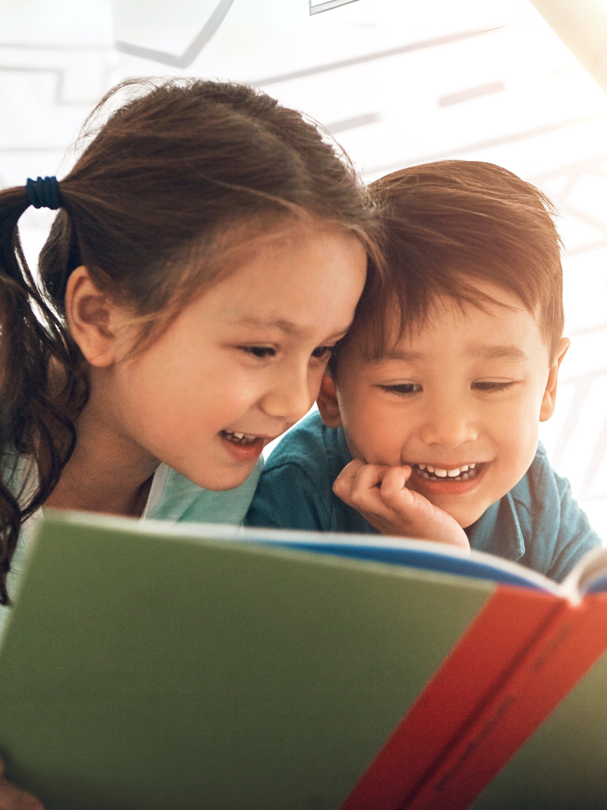 Siblings bonding over reading a book