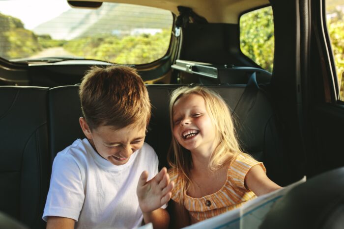 Two siblings bonding during a road trip.