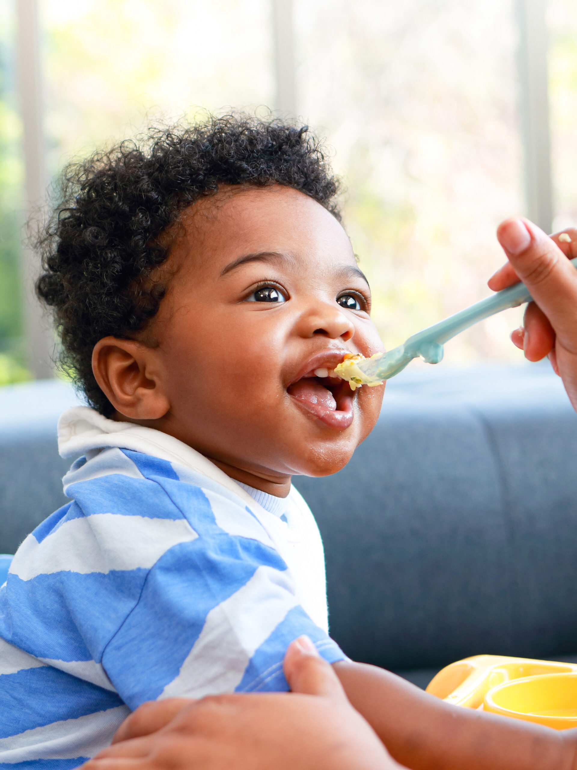 Toddler eating solids and smiling