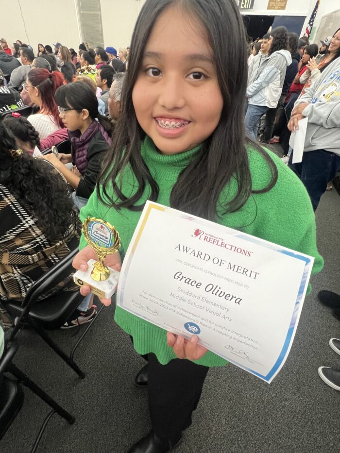 Child receiving a merit award 