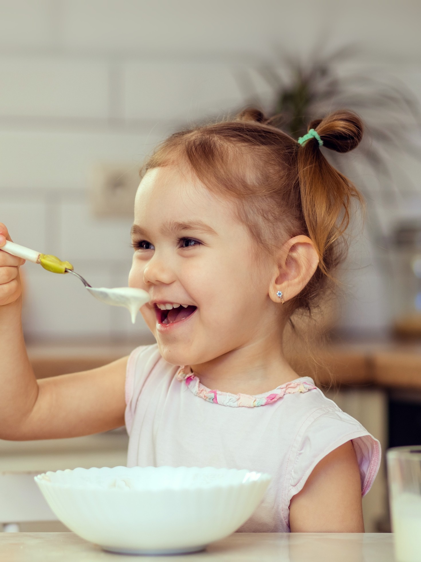 Happy little girl child 2-3 years old eats protein-rich snacks