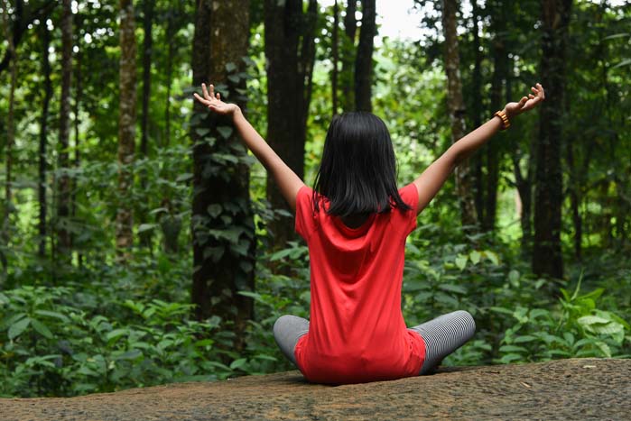 Child in woods relaxing
