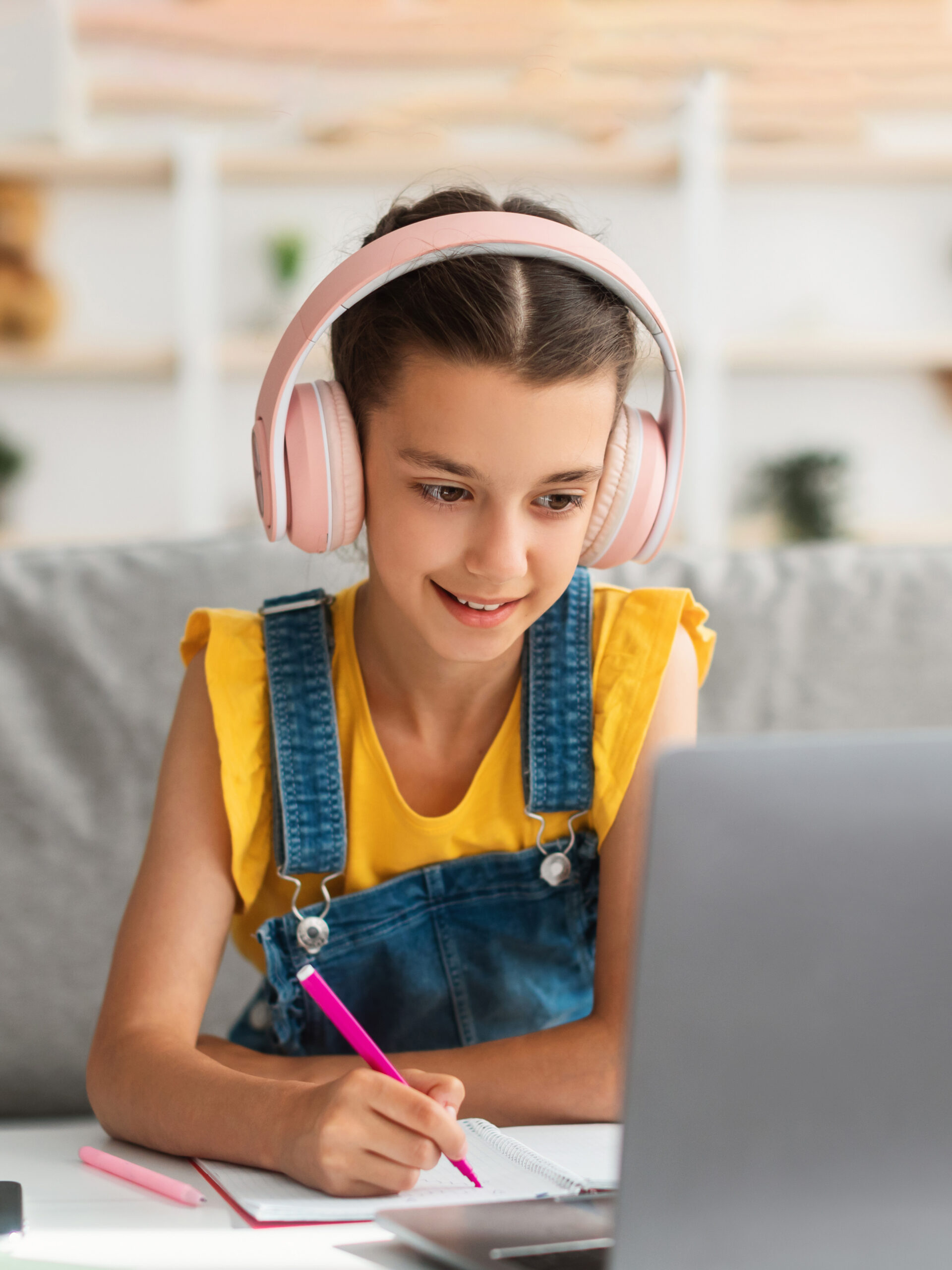 Girl reads laptop.