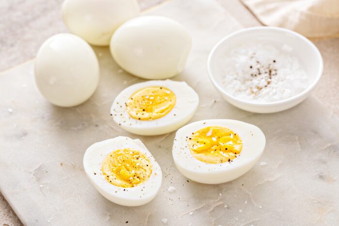 Hard boiled eggs peeled and cut in half with salt and pepper
