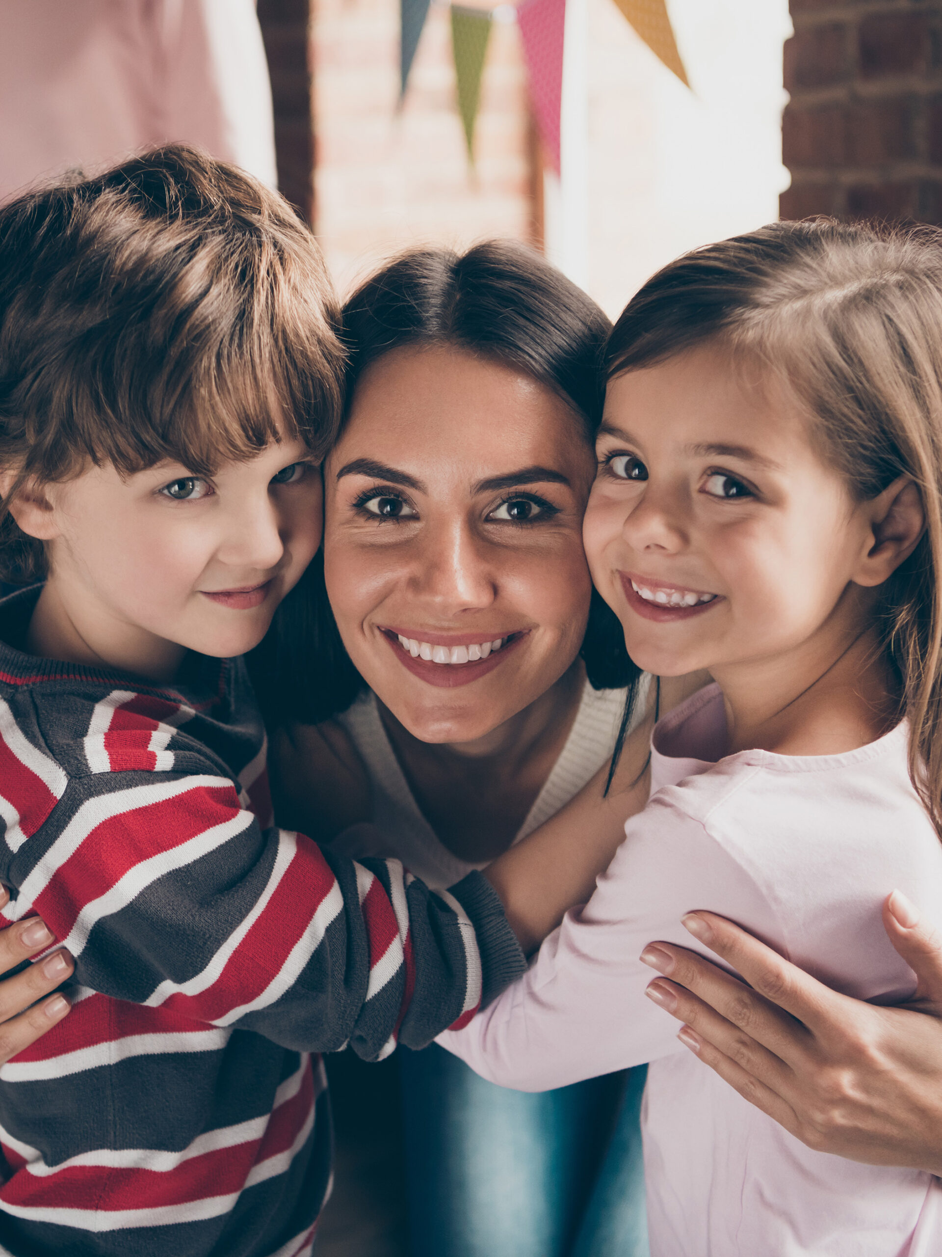 Woman with two kids smile