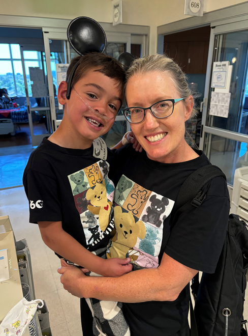Nurse Cynthia and Elijah wearing matching Choco shirts