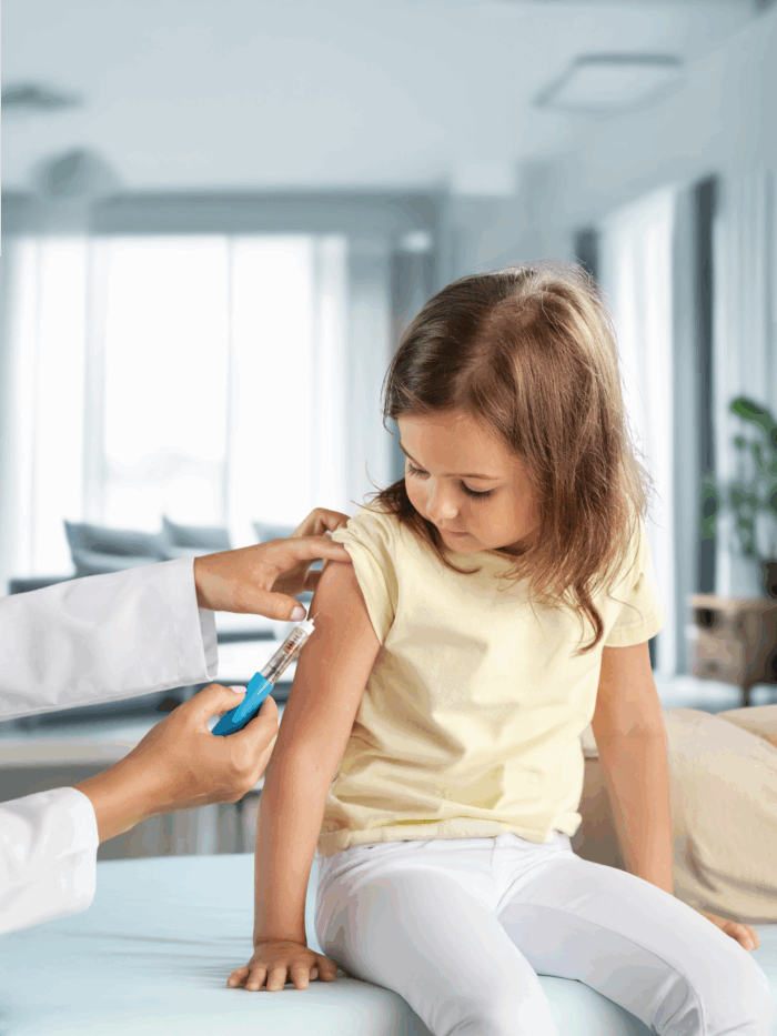 Child receiving her back-to-school vaccines