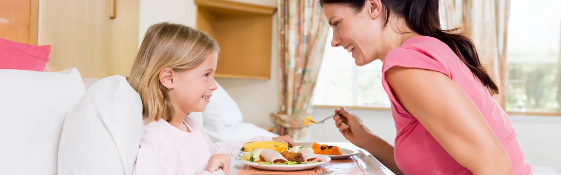 mother feeding her daughter