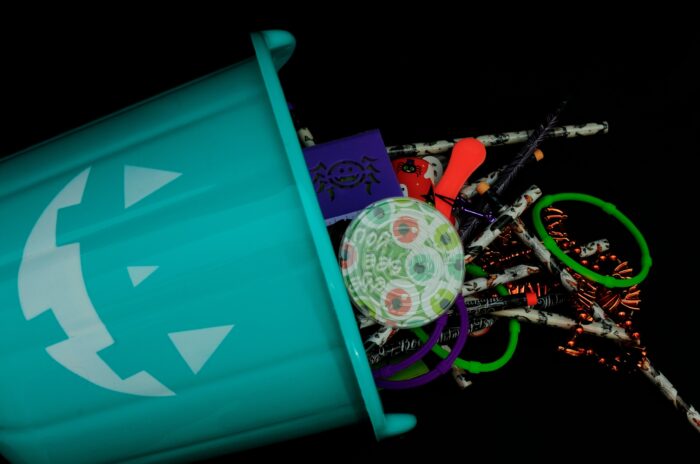 teal pumpkin bucket with non candy items. Necklaces, bracelets, games and pencils. for those who can not have candy or learning disabled