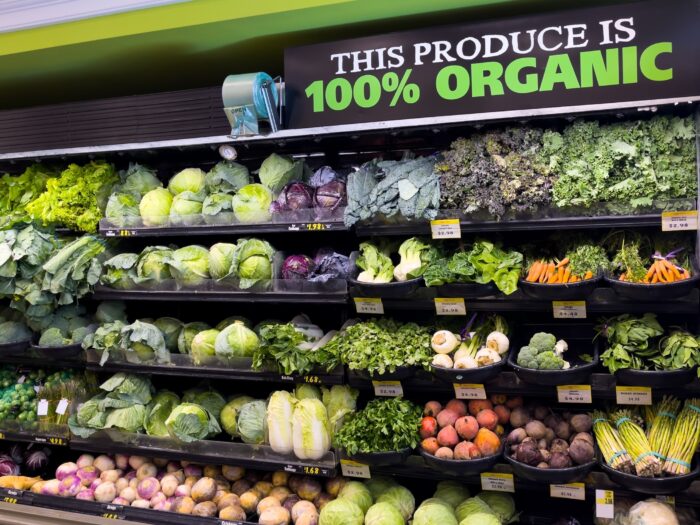 Fresh organic vegetable selection in produce aisle at grocery store supermarket.