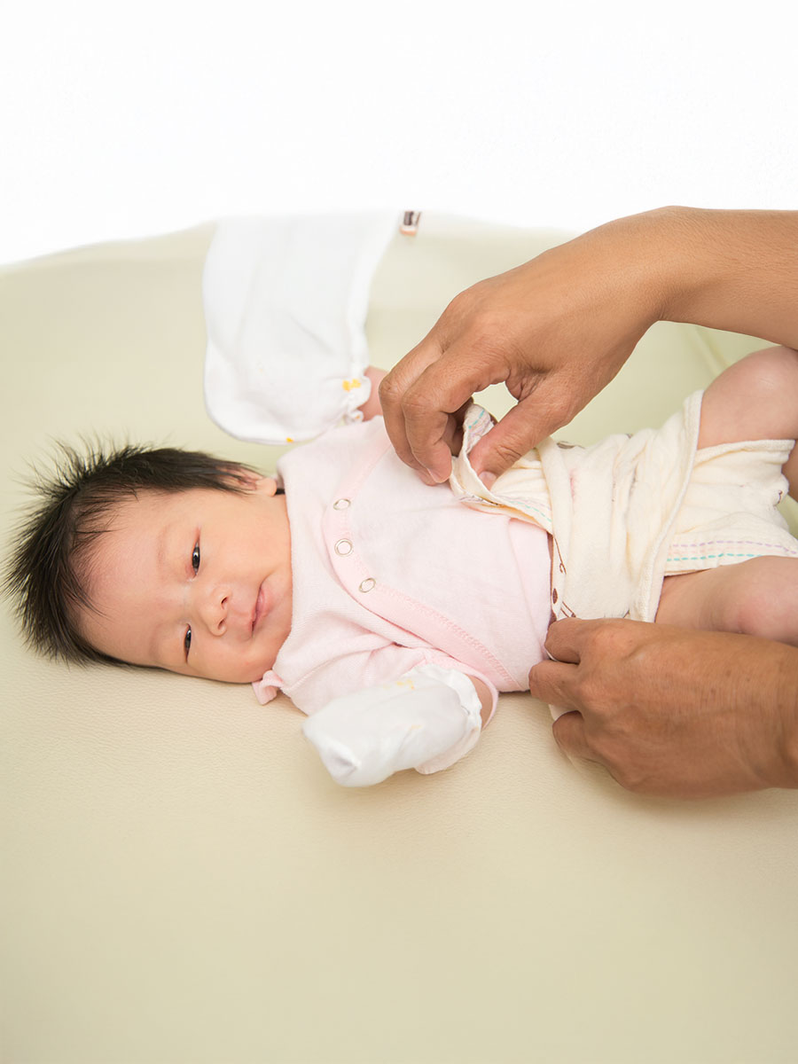 Grand mom hand wearing changing new not instant diapers for baby